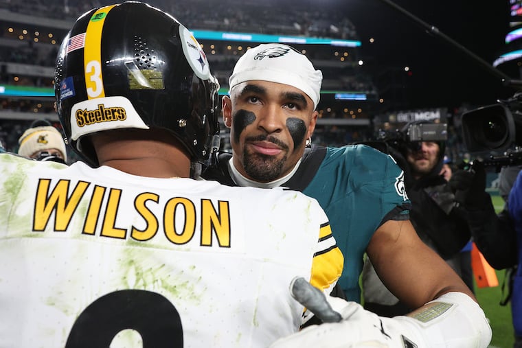 Jalen Hurts and Russell Wilson embrace after Sunday's game at the Linc.