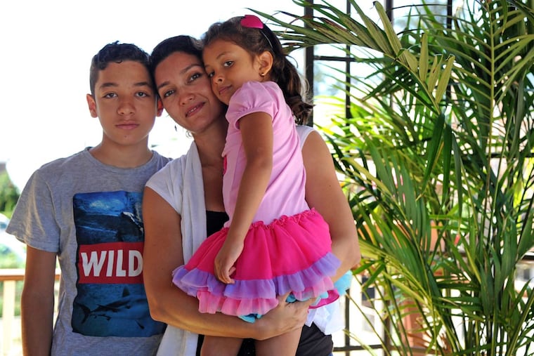 Ximena Estrada with her children Juan and Emily. With their passports safely returned, they are to return to Colombia on Tuesday.