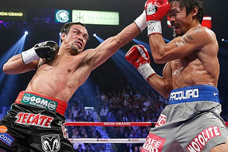 It will go down among the great fights of their era. But it was barely over when the cry arose for Manny Pacquiao and Juan Manuel Marquez to do it again. (Eric Jamison/AP)