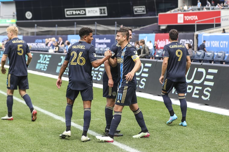 Alejandro Bedoya (11) celebrates with Nathan Harriel (26) after scoring the Union's opening goal.