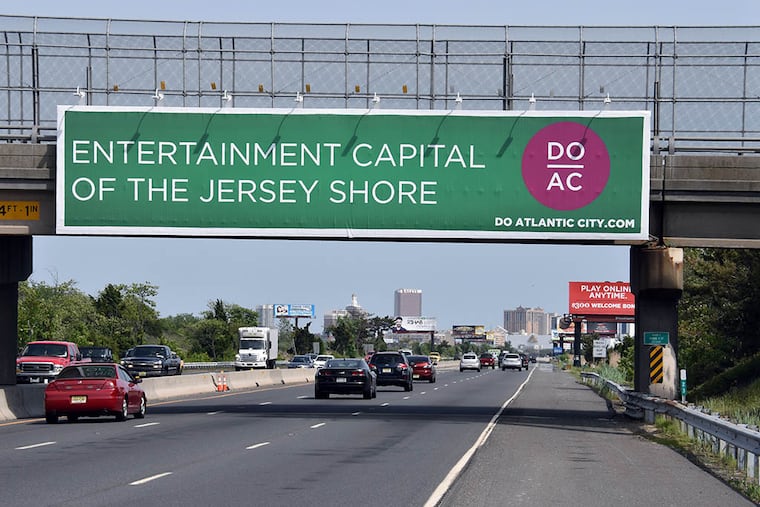The newly replaced signage, just east of Exit 2, on the Atlantic City Expressway. The sign replaced the old “One Mile to a Million Miles Away” sign that was removed last week for lack of a permit. (GREGG KOHL / For The Inquirer)