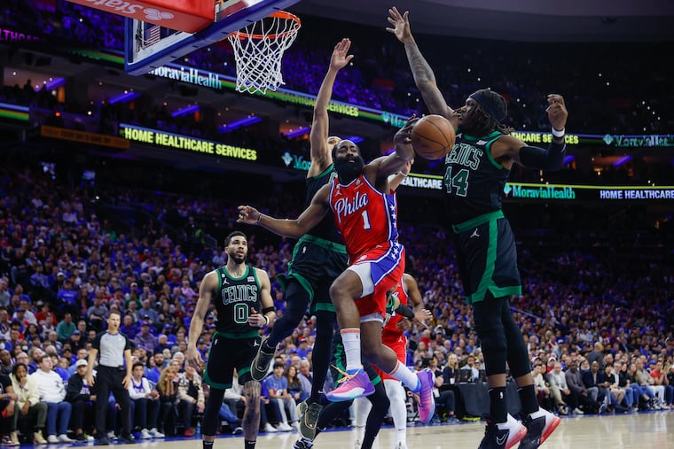 James Harden (center) passes the basketball past Celtics center Robert Williams III (right) and guard Derrick White in the first quarter of Game 3. Harden finished with 16 points on Friday.