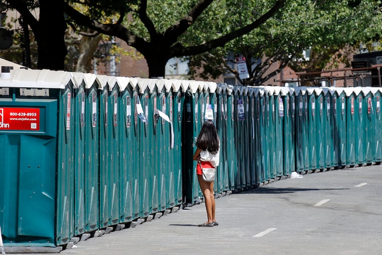 Attendees wait to use portable toilets at the Made In America festival in 2015.