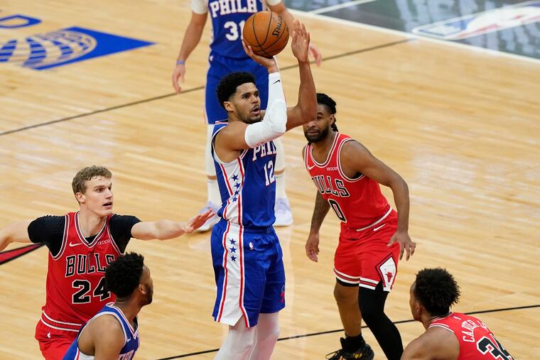 Sixers forward Tobias Harris (12) goes up for a shot as Chicago forward Lauri Markkanen (left), guard Coby White, and center Wendell Carter Jr. (right) watch during the third quarter of Thursday's game.