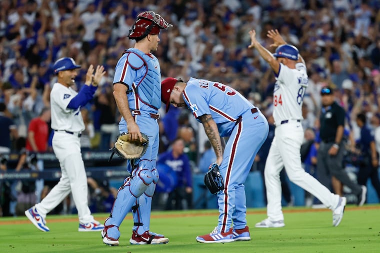 Catcher J.T. Realmuto consoles Orion Kerkering after the reliever's costly throwing error gave the Dodgers a 2-1 win in Game 4 of the NLDS.
