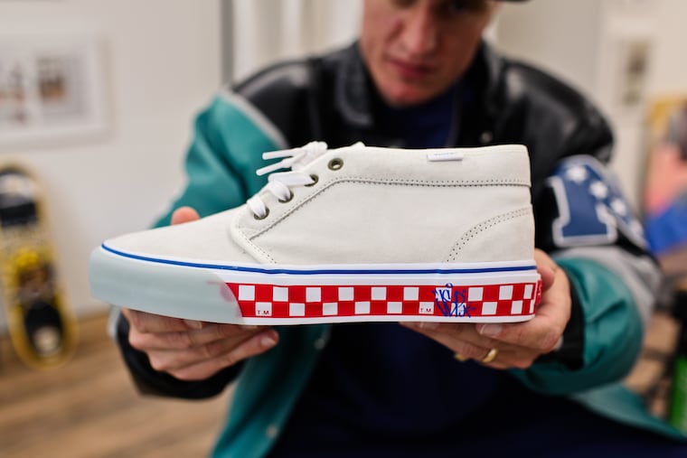Veteran skateboarder Jimmy Gorecki holds a shoe he designed for a collaboration with Vans that is inspired by Philly.