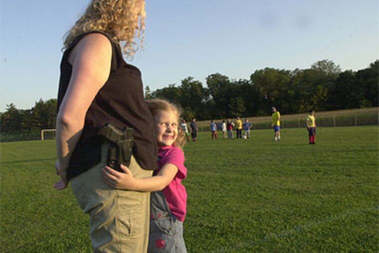 Meleanie Hain with daughter, Isabella, 5, a year ago. Hain, who gained notoriety for openly carrying a gun, was apparently shot dead by her husband. (AP Photo/ Lebanon Daily News, Jim Zengerle, File)