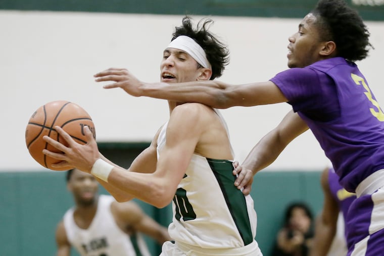 Camden Catholic's Valen Tejada (No. 10, with basketball) drives past Camden's Nasir Lett in the host Irish's 57-54 win over the Panthers on Friday.