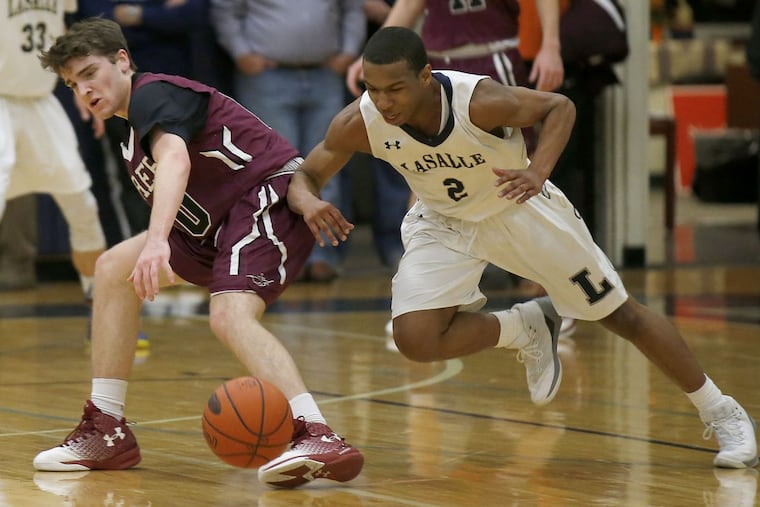 La Salle High’s Jarrod Stukes (right) goes after a loose ball with St. Joseph’s Prep’s Brian Griffin in February 2016.