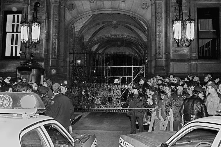 A crowd gathers outside the Dakota apartment building after John Lennon, who lived there, was shot hours earlier in front of the building when returning home on the evening of Dec. 8, 1980.