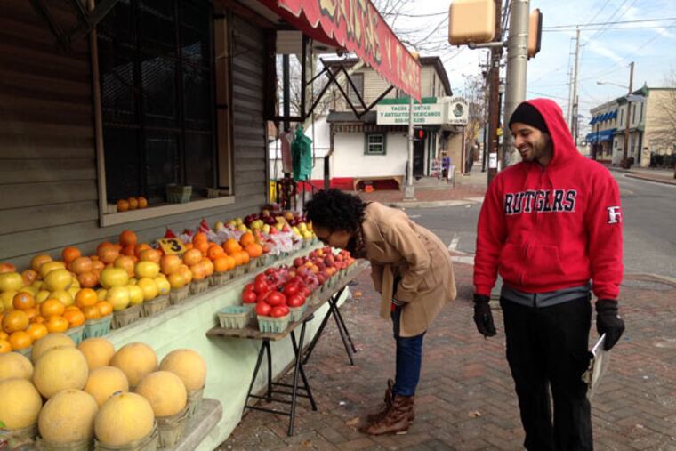 Zaid Mazahreh (right) and Danielle Davis survey the Cramer Hill neighborhood of Camden, inputting information in their iPhones as part of the Camden Neighborhood Change Study.