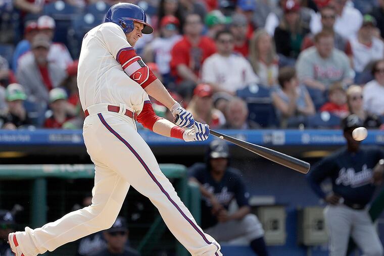 PhilliMichael Saunders hits a lead-off double against the Atlanta Braves.