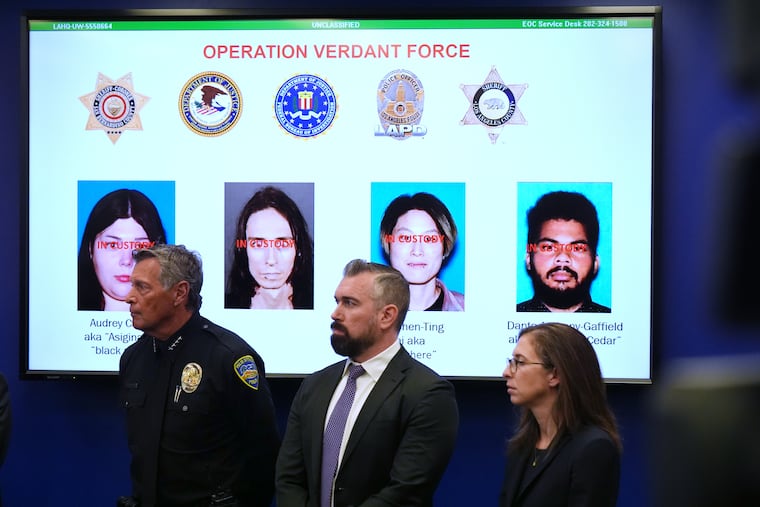 Photos of suspects in a terror plot are shown on a screen during a news conference Monday, Dec. 15, 2025, in Los Angeles.