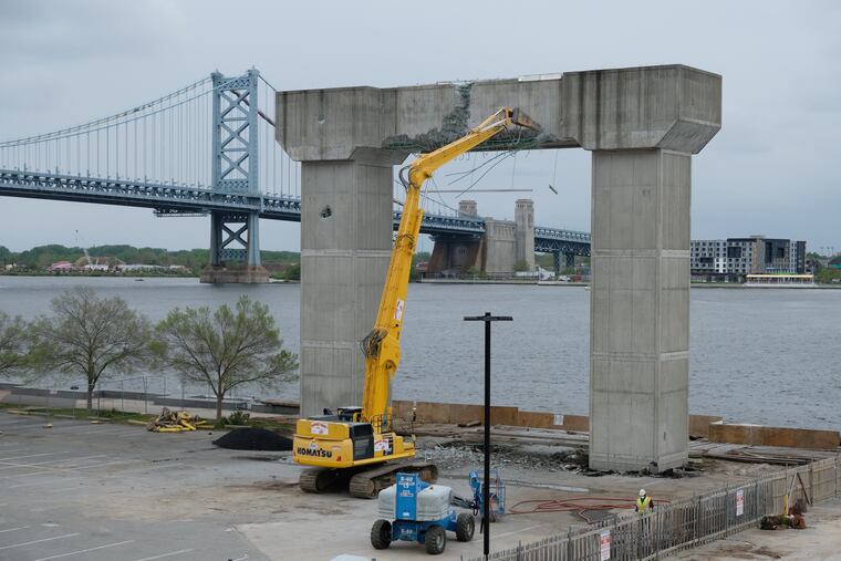 Crews are demolishing the cement tower on near Penn's Landing's Great Plaza amphitheater that was built almost two decades ago to anchor an ill-fated tramway to Camden.
