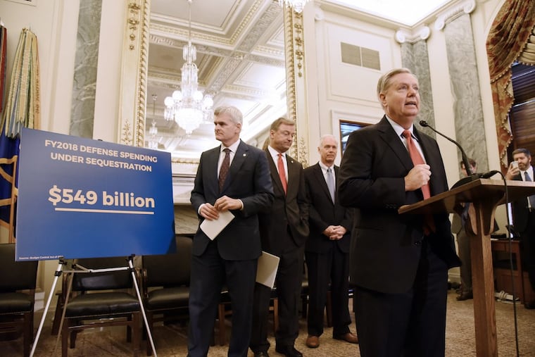 U.S. Sen. Lindsey Graham (R., S.C.) speaks as Sen. Bill Cassidy (R., La.), Sen. Dean Heller (R., Nev.), and Sen. Ron Johnson (R., Wis.) listen during a Sept. 13 news conference on health care on Capitol Hill in Washington.