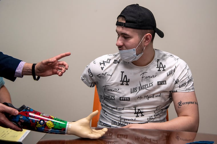 Roman Horodenskyi is fitted for a bionic prosthetic arm and hand at Eddystone office of Prosthetic Innovations in September. He is a Ukrainian Marine from Odesa who was injured in a Russian artillery attack in April. Revived Soldiers Ukraine, a nonprofit founded in 2015 that brings seriously wounded troops to the United States for advanced treatment and surgeries, worked with Horodenskyi to get both a new below-the-knee prosthetic leg and prosthetic arm.