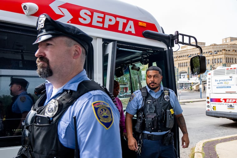 SEPTA transit police patrol officers Brendan Dougherty (left) and Nicholas Epps (right) with the Fare Evasion Unit leave the Rt. 21 bus at the 69th Street Terminal in 2025.