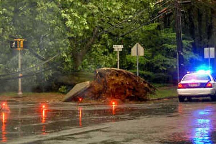 File photo: A corner of Kings Highway and Warwick Road in Haddonfield was in need of emergency work after a tree knocked down power lines in 2010. The storm affected about 4,000 PSEG customers in Burlington and Camden Counties. Also, 40,000 Atlantic City Electric customers lost power. (File photo: Tom Gralish / Staff Photographer)