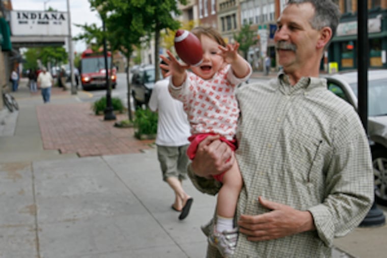 "I've never heard anything bad about Jimmy Stewart," says Harry Spielman, with his granddaughter, Stella, on Indiana, Pa.'s main drag. At right, on the lawn of the county courthouse, a statue of Stewart, Indiana's home-town angel who made it big in Hollywood, earned his wings during WWII, and embodied American aw-shucks values.
