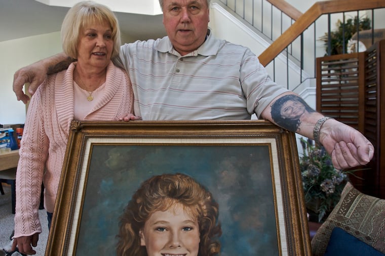 Stephen and Esther Anderson, in 2009, in their Mount Laurel home as they prepare to move. Portraits of their slain 12-year-old daughter, Kim who was murdered 21 years ago hang on the walls of the dinning room and den.