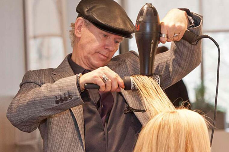 Paul Labrecque blow-dries a client's hair at his three-month-old salon in the Rittenhouse hotel. (RON TARVER / Staff Photographer)