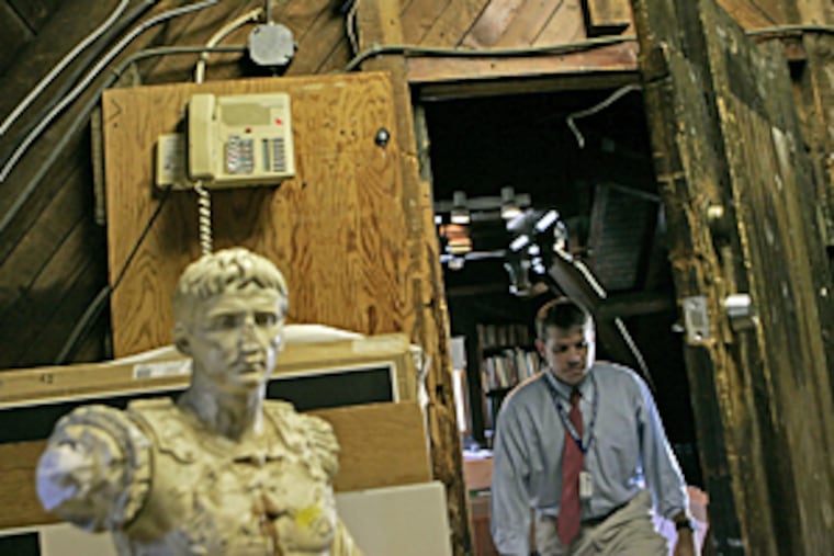 With existing space scarce at Episcopal Academy, artwork is stored in the attic of an old carriage house on the Merion campus. Michael Letts prepares it for the move to a larger, less urban site in Newtown Square, Delaware County.