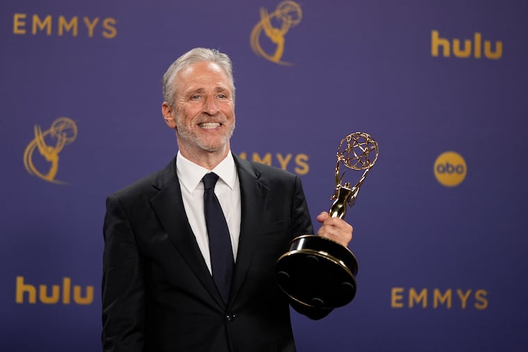 Jon Stewart poses in the press room with the award for outstanding talk series for "The Daily Show" during the 76th Primetime Emmy Awards in September at the Peacock Theater in Los Angeles.