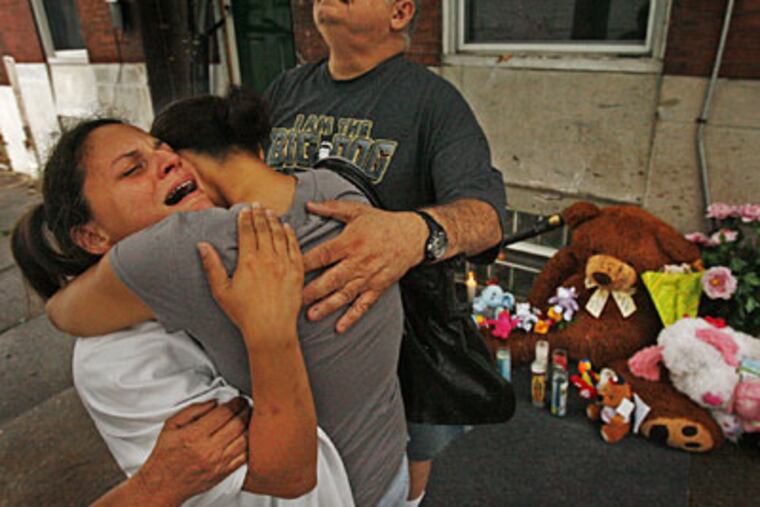 Tammy Rosario (left), mother of Gina Marie Rosario, 7, who was one of three children killed by a car, being consoled by her sister Natalie Elias. Rosario's uncle Angelo Betancourt, looks to the sky. (Alejandro A. Alvarez / Staff Photographer)