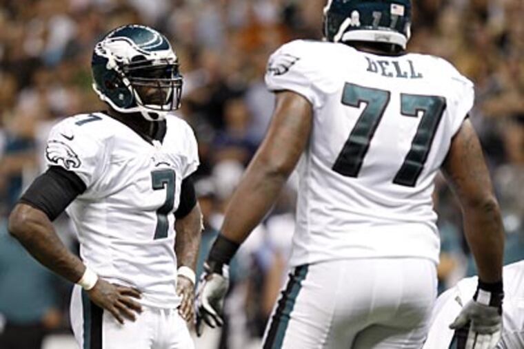 Eagles quarterback Michael Vick and offensive lineman Demetress Bell. (Yong Kim/Staff Photographer)