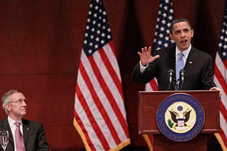 President Barack Obama during his visit to Capitol Hill to meet with House Democrats on Saturday. Seated on the left, Senate Majority Leader Harry Reid, D-NV. (AP Photo/Pablo Martinez Monsivais)