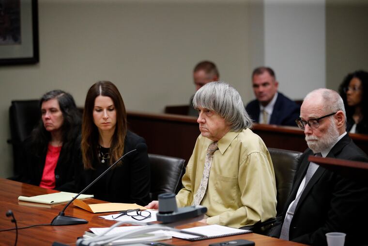 David Turpin (second from right) and his wife, Louise (far left), sit in a courtroom with their attorneys, Allison Lowe (second from left) and David Macher Friday, Feb. 22, 2019, in Riverside, Calif. The California couple who shackled some of their 13 children to beds and starved them have pleaded guilty to torture and other abuse.
