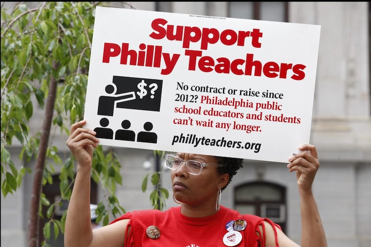 Aura Townsend, an English Teacher from from George Washington Carver High School of Engineering and Science, protests in front of City Hall, as teachers called out of work as part of a citywide action to protest four years without a contract in May 2017.