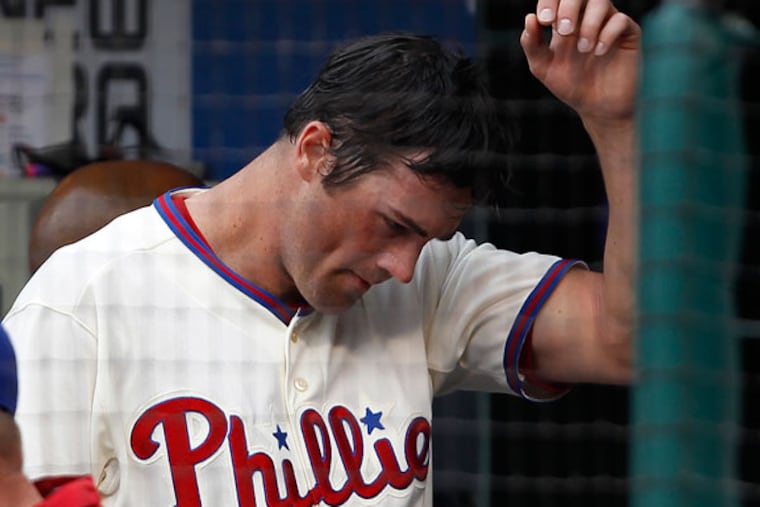 Cole Hamels walks through the dugout in the third inning. (David Maialetti/Staff Photographer)