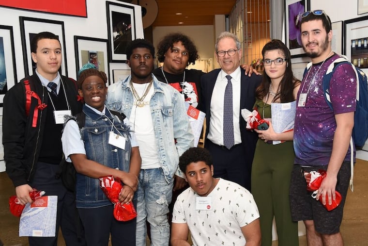 Jack Ludmir, executive director of the Philadelphia Collaborative for Health Equity, poses with Latino students from North Philadelphia who contributed photos of their neighborhood to the collaborative's health assessment report.
