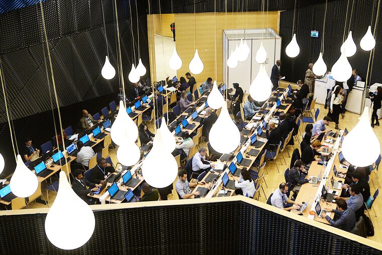 Participants work in a computer room during the Climate Change Conference COP24 in Katowice, Poland, Tuesday, Dec. 4, 2018. (AP Photo/Czarek Sokolowski)