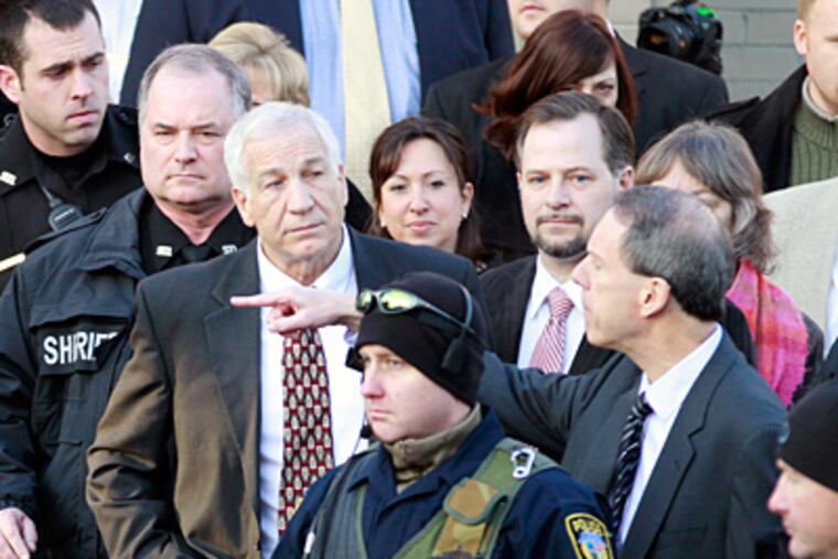 Jerry Sandusky (left) is under house arrest with electronic monitoring after posting $250,000 bail last week. (David Swanson / Staff Photographer)
