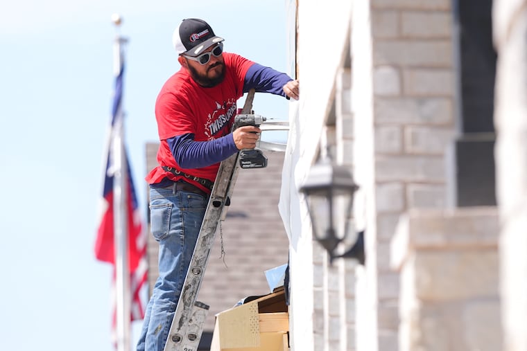 A worker installs a window on a house under construction in Richardson, Texas, Monday, March 23, 2026.