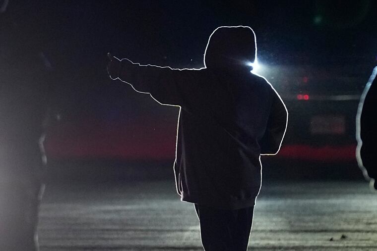 A woman gives a 'thumbs up' as she, family members and others affected by the Robb Elementary shooting leave a meeting where Attorney General Merrick Garland shared a report on the findings of an investigation into the 2022 school shooting on Wednesday in Uvalde, Texas.
