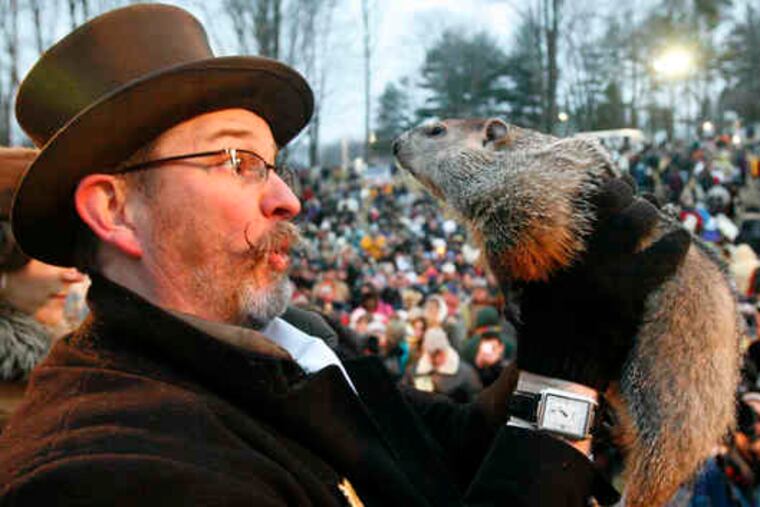 Punxsutawney Phil gives the bad news to Ben Hughes on Gobblers Knob. He saw his shadow - and six more weeks of winter weather. Phil also text-messaged his forecast and went on Twitter.