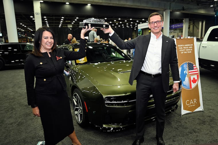 Audrey Moore, Stellantis vice president North America sedan programs, and Dodge CEO Matt McAlear hold up the North American Car of the Year Award in front of the Dodge Charger, Wednesday, Jan. 14, 2026, in Detroit.