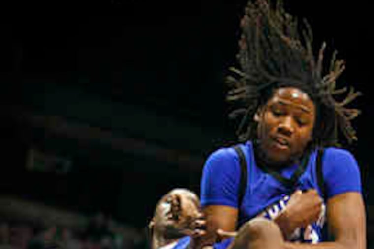 Camden Catholic's Sherard Cadogan attempts to hold on to the loose ball against the Iron Mikes' Brandon Taylor (right).