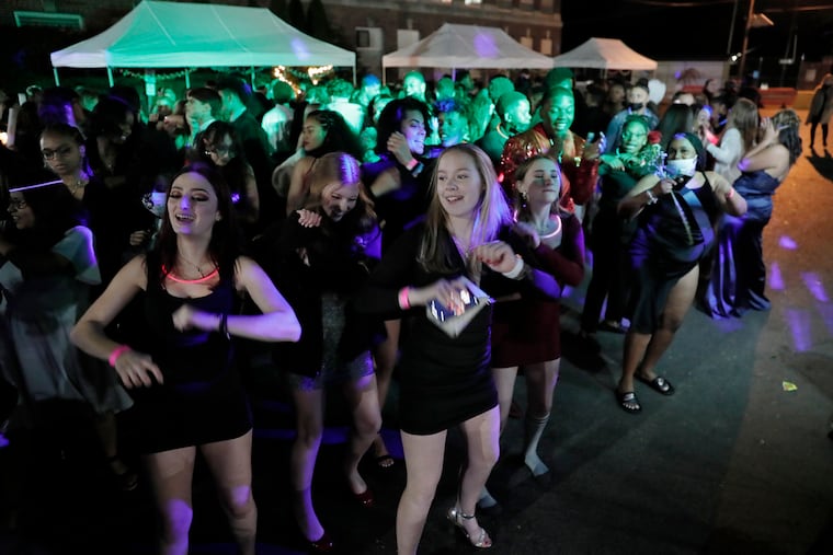 Kids do the Cupid Shuffle during Collingswood High School’s outdoor homecoming dance, at the school, on Nov. 3, 2021.