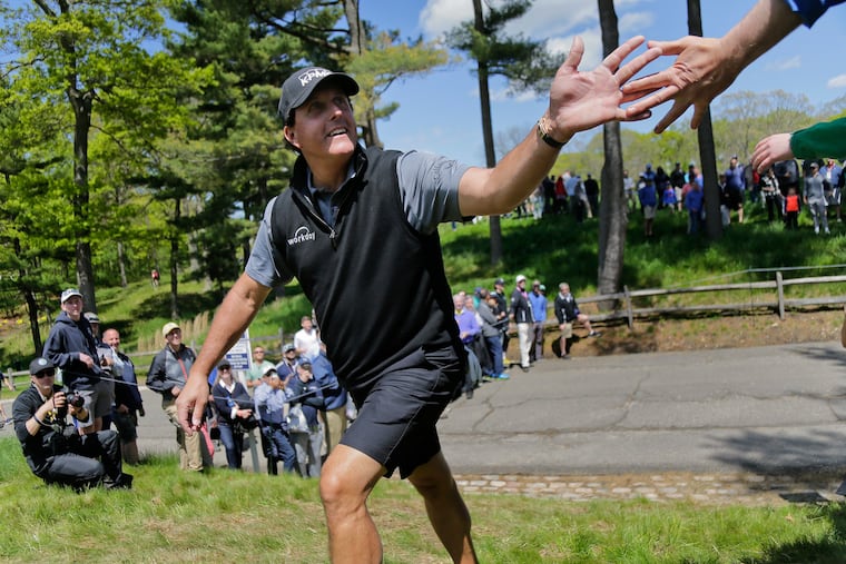 Phil Mickelson greets fans on his way to the 13th tee during a practice round for the PGA Championship golf tournament, Wednesday, May 15, 2019, at Bethpage Black in Farmingdale, N.Y. (AP Photo/Seth Wenig)