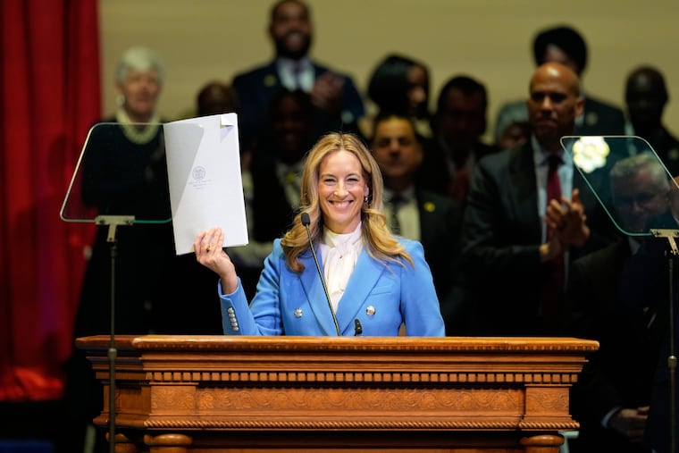 New Jersey Gov. Mikie Sherrill holds up a just signed executive order during her inauguration ceremony in Newark, N.J., Tuesday, Jan. 20, 2026.