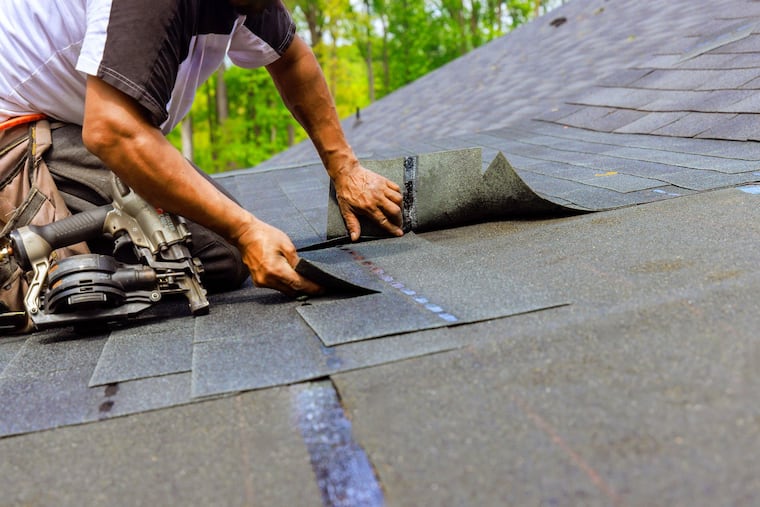 A roofer installs new shingles on a home. Delaware Valley Consumers’ Checkbook found that higher prices do not indicate better quality when shopping for a roofer.