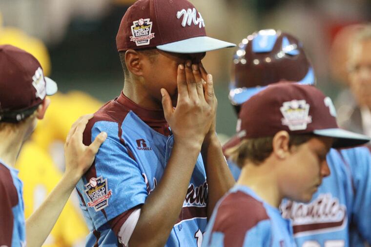 Taney's Joe Richardson, center, has to cover his tears as he walks to the dugout after the lost to Jackie Robinson West, 6-5. ( MICHAEL BRYANT / Staff Photographer )