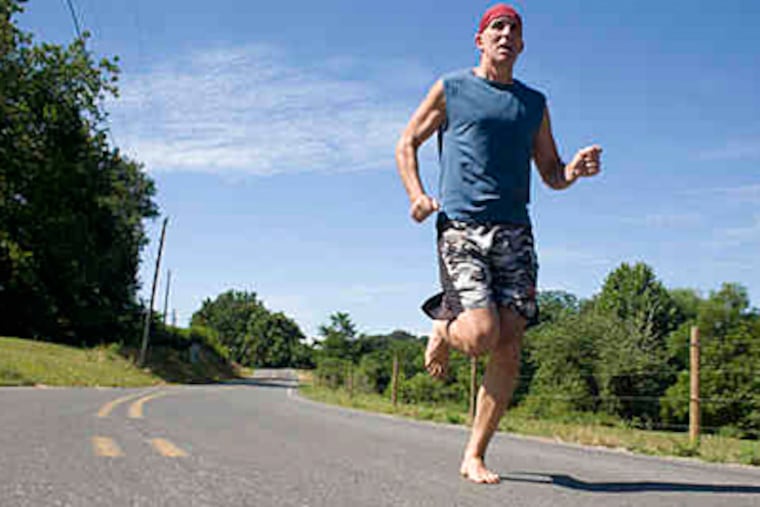 Barefoot, Christopher McDougall takes a run near his Peach Bottom home. (Ed Hille / Staff Photographer)