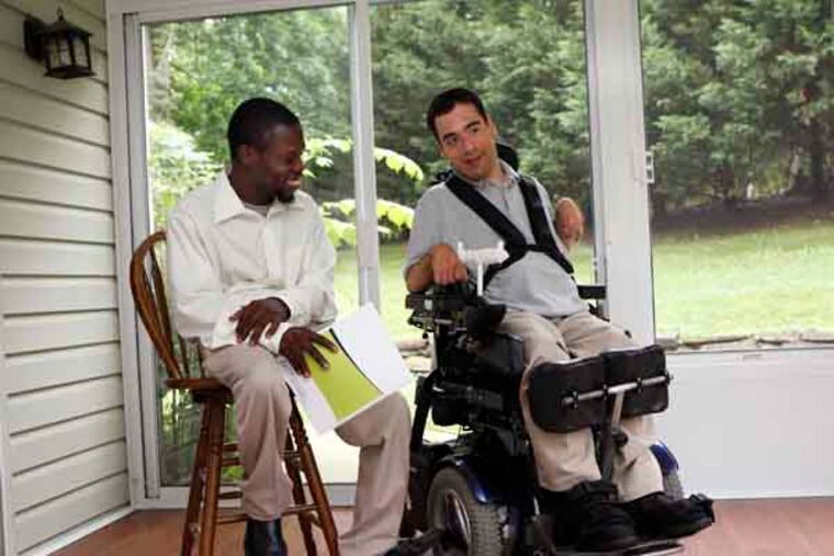 Matthew Saunders (left) and Michael Anderson (right) discuss "Cents and Sensibility," a guide to money management for people with disabilites. They helped simplify terms in the book which was developed by the Pennsylvania Assistive Technology Foundation in conjuntion with Widner University. July 1, 2013. MICHAEL S. WIRTZ / Staff Photographer