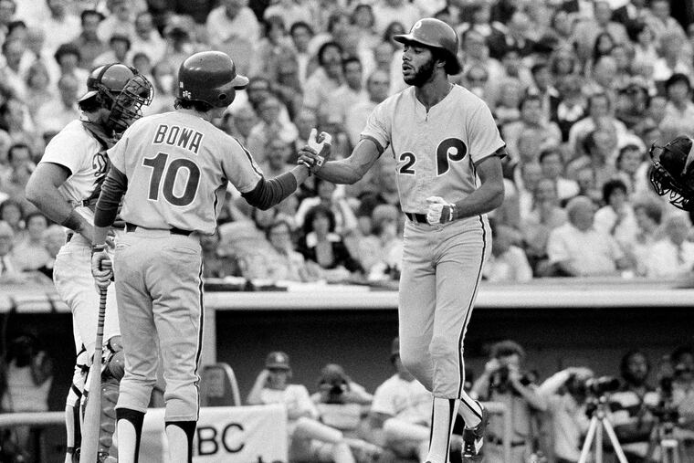 Phillies outfielder Bake McBride crossing home plate and being met by teammate Larry Bowa after hitting a home run against the Dodgers in the 1977 playoffs.