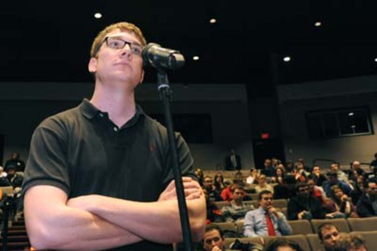 JRUTGERS31P3 At Rutgers Camden, law students get a briefing on he proposed merging with Rowan College. Here, Kevin Miller asks a question. 1/30/12 APRIL SAUL / Staff Photographer